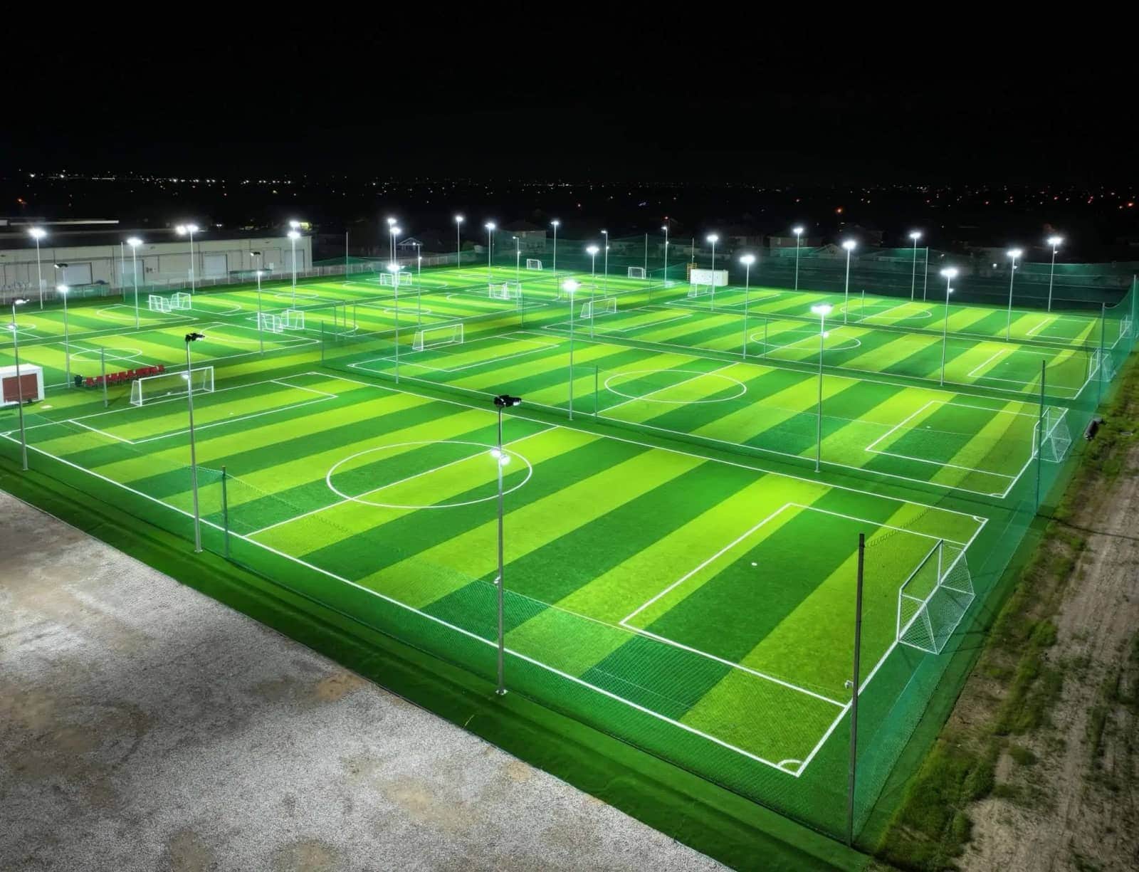 Floodlit outdoor turf fields at night at Houston Soccer Field